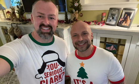 Derrick and husband wearing Christmas t-shirts