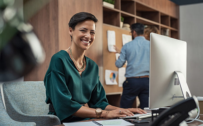 Smiling office employee working at a desk