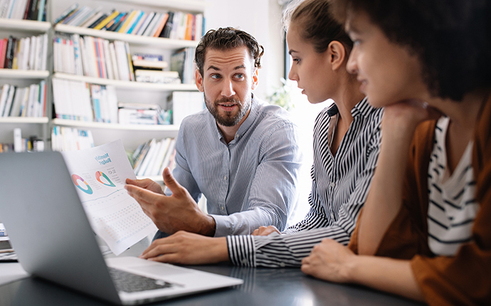 Group of employees discussing a report