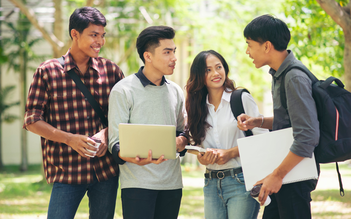 group of international students talking on campus grounds