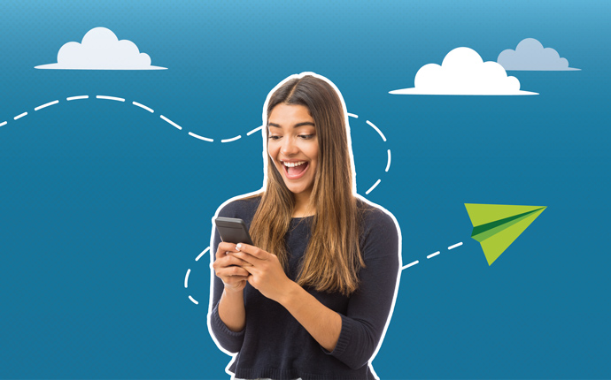 A green paper airplane flying by a smiling student who's receiving a notification on her cellphone