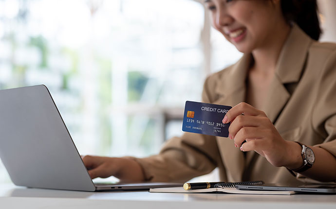 an individual holding a credit card to use in an online transaction