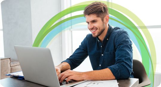 Smiling person using a laptop computer